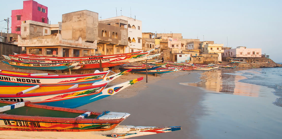 Colourful fishing boats line the shores of Dakar